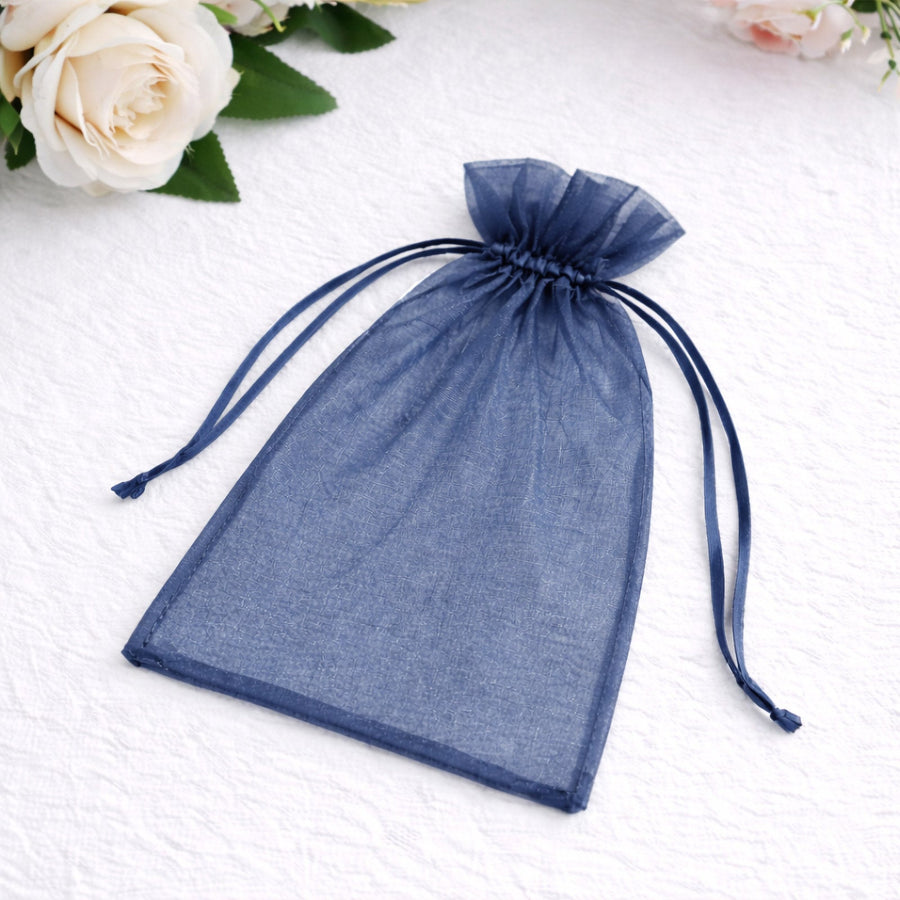 Navy blue organza drawstring bag on a plain background