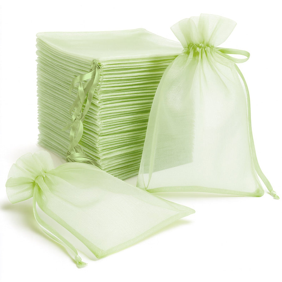 Green organza bags and matching tissue paper stacked together for gift wrapping.