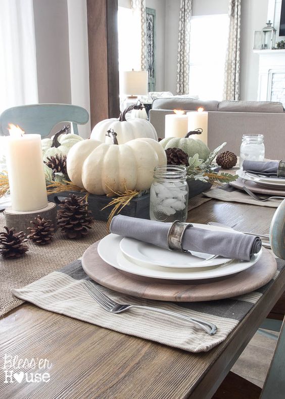 Pumpkin centerpiece on a white table with pink accents