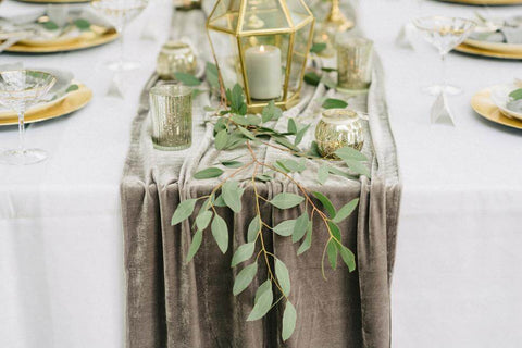 Velvet table runner with greenery and candle centerpiece
