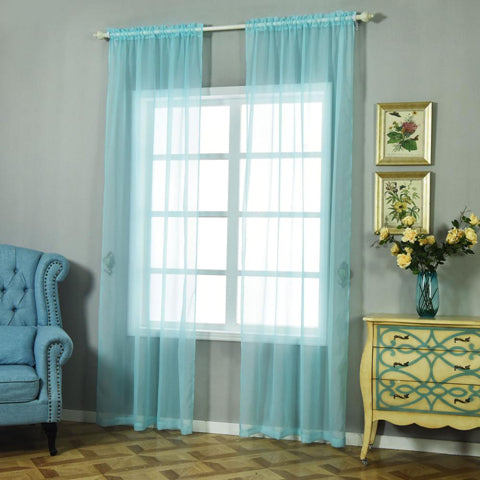 Sheer turquoise curtains framing a window