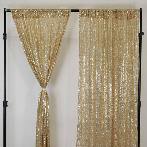 Gold sequin curtain panels on a stand