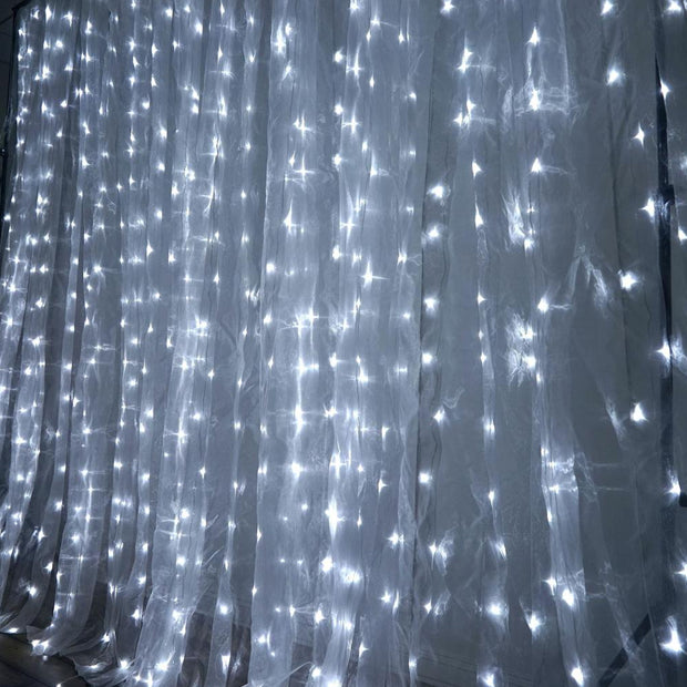 White sheer curtains with string lights