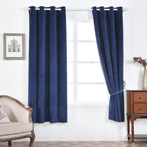 Navy velvet curtains hanging beside a window