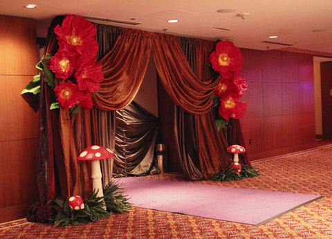 Velvet draped entrance with red floral accents