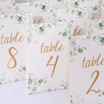 25-Pack Paper Wedding Table Numbers 1-25 White/Green Eucalyptus Leaves Design - Free Standing Double Sided Table Signs with Glam Gold Foil Numbers 7"