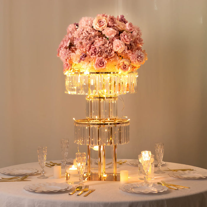 Elegant floral centerpiece with pink roses and crystal accents on a dining table.