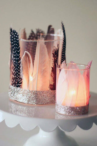 Feathers in glass candle holders