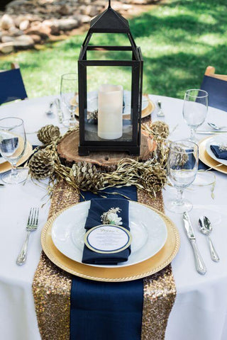 Gold sequin runner, navy napkins, and white tablecloth