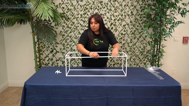 Woman assembling a white metal flower stand