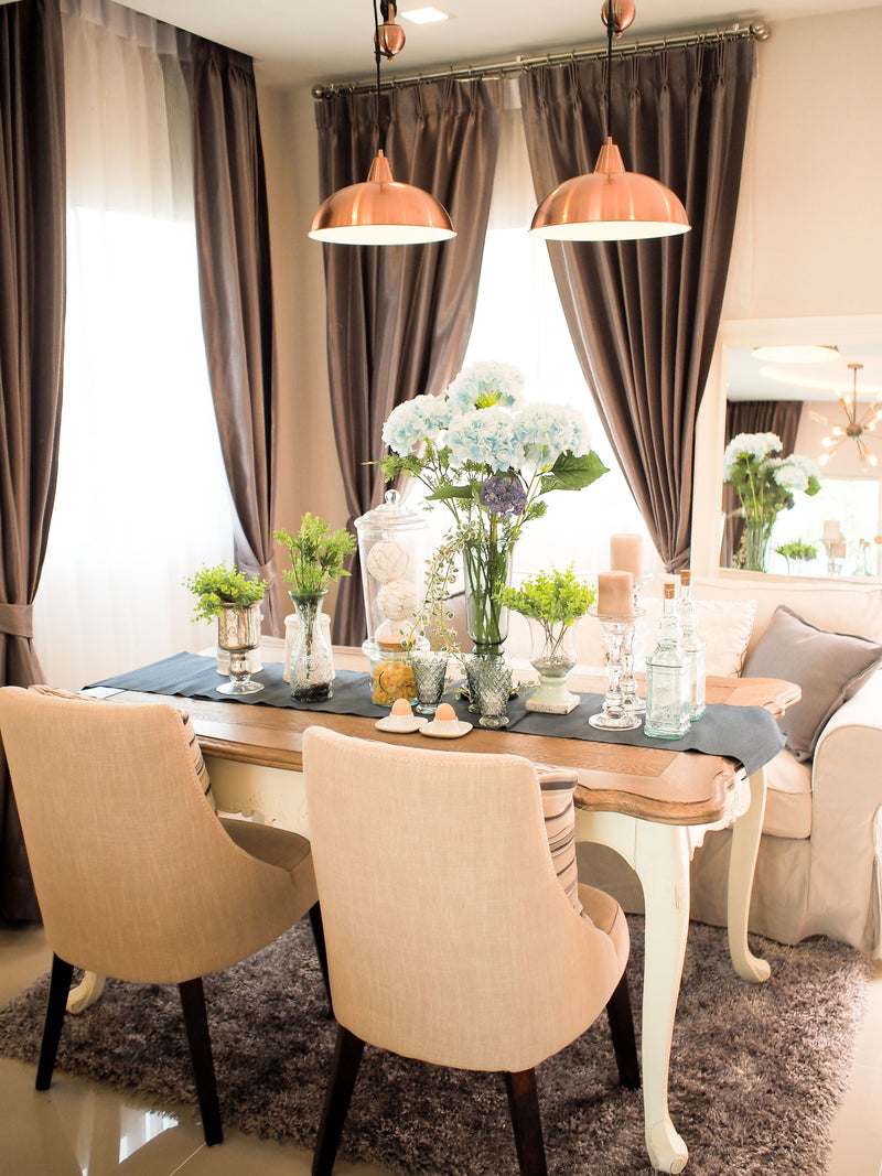 Kitchen table with blue runner and flowers