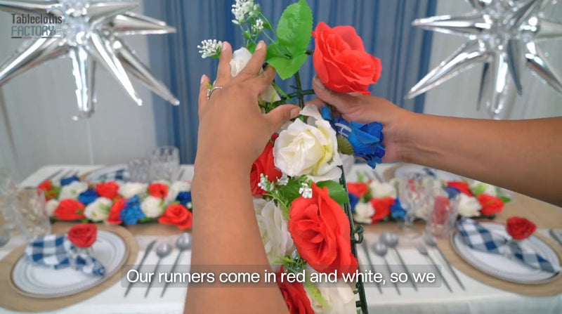 Adding red, white, and blue flowers to complete 4th of July table setup decor.