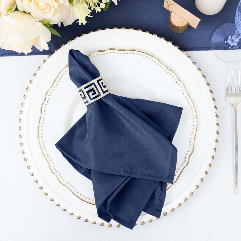 Navy blue napkin with Greek key ring on a place setting