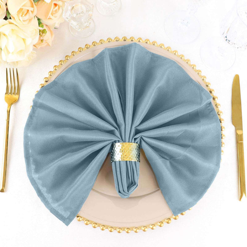 Dusty blue napkin with gold napkin ring