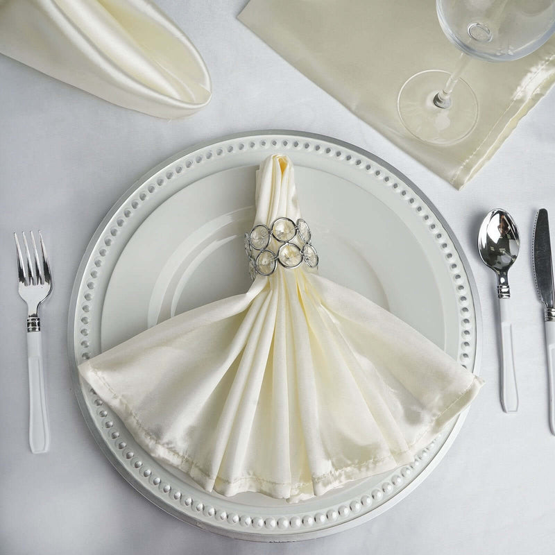 Ivory satin dinner napkin on a white place setting