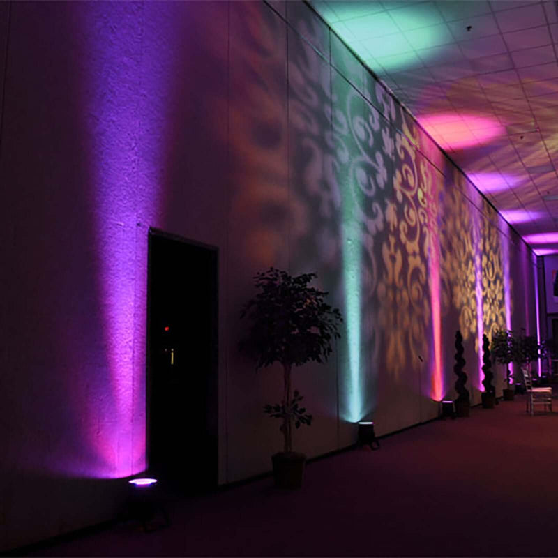 Purple and teal uplighting on a hallway wall