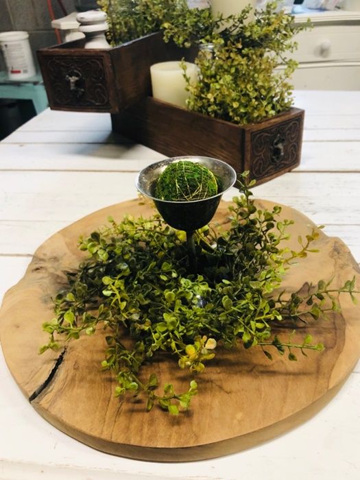 Moss centerpiece in a black bowl on a wooden tray