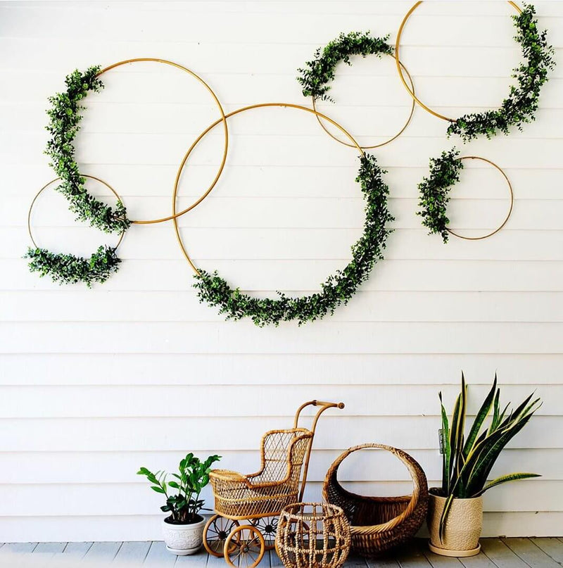Green wreath wall decor with hanging plants