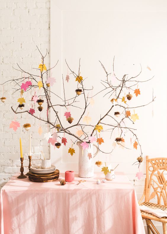 Autumn centerpiece with branches and colorful leaf garland