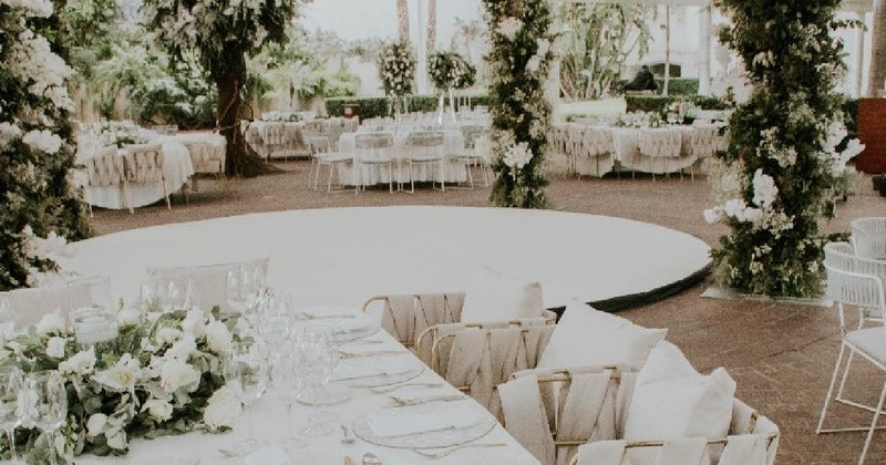 Garden reception with round tables and white florals