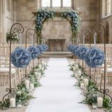 Elegant blue rose floral arrangements decorate a wedding aisle with candles and greenery.