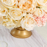 Gold base floral arrangement with cream and pink roses.