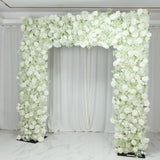 White floral arch adorned with roses and greenery for events and weddings.