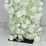 White faux floral arrangement with roses and hydrangeas.