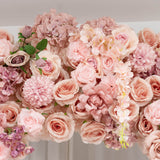 Pink and peach floral arrangement with roses and hydrangeas on a table
