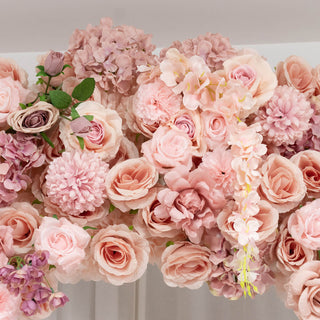Pink and peach floral arrangement with roses and hydrangeas on a table