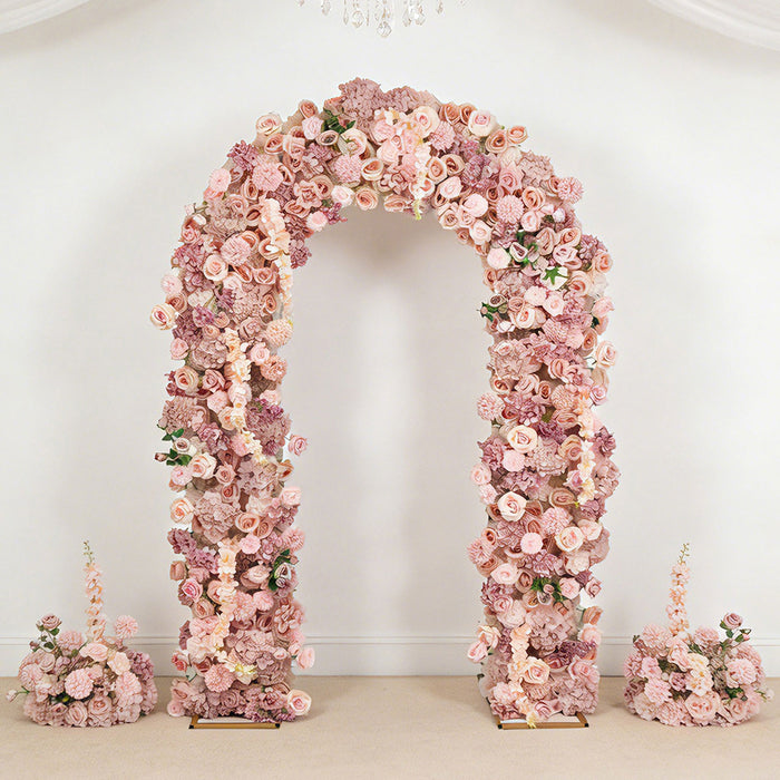 Pink floral arch wedding backdrop with matching flower arrangements