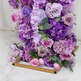 Lavender and pink artificial flower arrangement in gold box centerpiece