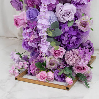 Lavender and pink artificial flower arrangement in gold box centerpiece