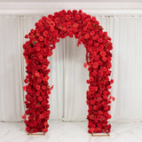 Red rose floral arch centerpiece with white drapery backdrop