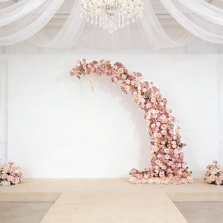 Elegant floral arch with pink blooms for weddings or events.