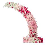 Floral arch arrangement in shades of pink and white on a white background