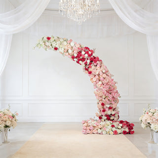 Floral arch made of pink and white roses in an elegant venue setting.