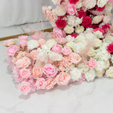 Assorted pink and white artificial flowers arranged beautifully.