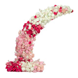 Colorful floral arch arrangement in shades of pink and white.