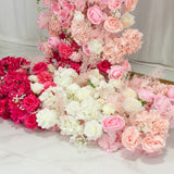 Assorted artificial flowers in shades of pink, white, and red arranged beautifully.