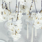 White cherry blossom garland with delicate flowers on dark hanging stems