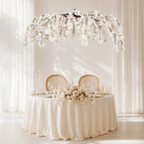 Elegant white floral wedding table setting with hanging cherry blossoms