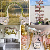 Elegant floral event decor with wedding arch, welcome sign, and balloon backdrop