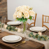 Elegant faux rose bouquet centerpiece on a beautifully set dining table.