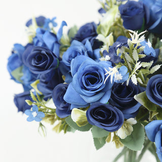 <p style="margin-left:0px;"><strong>Everlasting Beauty with Artificial Silk Roses</strong></p><p style="margin-left:0px;">The Navy Blue Artificial Silk Rose Bouquet serves as more than just a decoration, it also represents classic elegance. Each rose is designed to maintain its bright color and shape for eternity, offering a lovely alternative to fresh flowers that fade and change color. The bouquet's durability makes it ideal for events spanning several days or as a memento for long-lasting conservation.</p><p style="margin-left:0px;">Crafted from high-quality silk, these faux roses possess a lifelike appearance that can deceive even the most discerning onlooker. The intricate patterns on each petal and the realistic stems ensure that your floral arrangements display authentic artistic talent. These silk roses require no maintenance unlike real flowers, allowing you to enjoy their beauty hassle-free. Simply place them once and they will remain flawless, adding a long-lasting hint of sophistication to your event or home.</p><p style="margin-left:0px;">These artificial flowers are long-lasting and can be used multiple times for various occasions. This bouquet can be used for <strong>wedding decoration</strong>, anniversaries, home decoration, and corporate events. Its sturdy material makes it perfect for outdoor events too, where real flowers might get ruined by the weather. Embrace the ease and elegance of these silk rose arrangements that will always look good regardless of the occasion or location.</p>