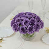 Purple roses bouquet in a glass vase on a dining table.