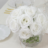 White roses bouquet in a clear glass vase.