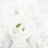 White fabric roses in a close-up arrangement.