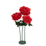 Three vibrant red artificial roses with green stems in a modern vase. #whtbkgd