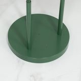 Green metal base of a standing lamp on a marble surface.